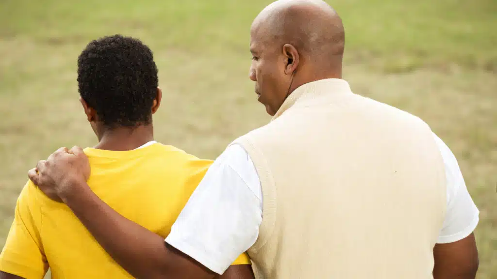 Father holding son's shoulder