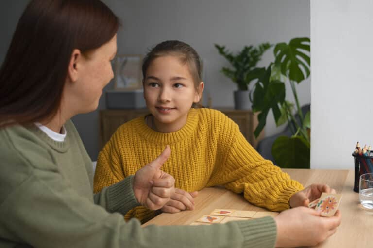 Mother and daughter sitting at a table, engaging in a warm and meaningful conversation in a cozy home setting.