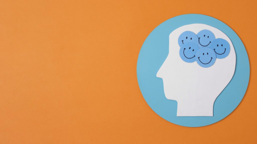 Illustration of a human head with brain gears, symbolizing cognitive processes, on an orange background.